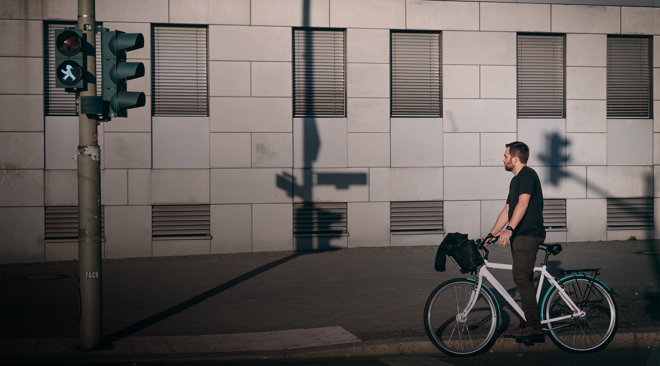 Cyclist waiting at a light with a GPS tracker attached to his bike